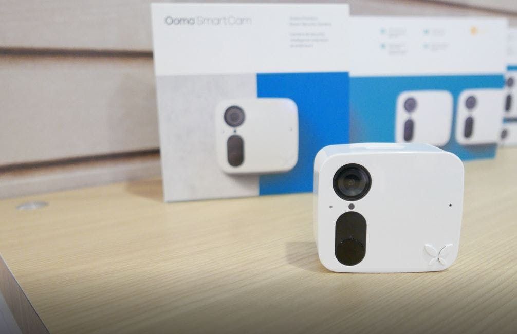 Ooma white security camera on the table. Ooma white security camera on the table.