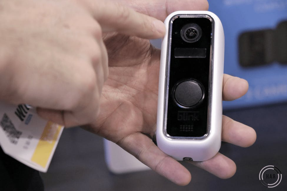 Man holding Blink video doorbell. Man holding Blink video doorbell.