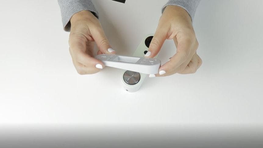 A girl holding the Simplisafe Video Doorbell. A girl holding the Simplisafe Video Doorbell.